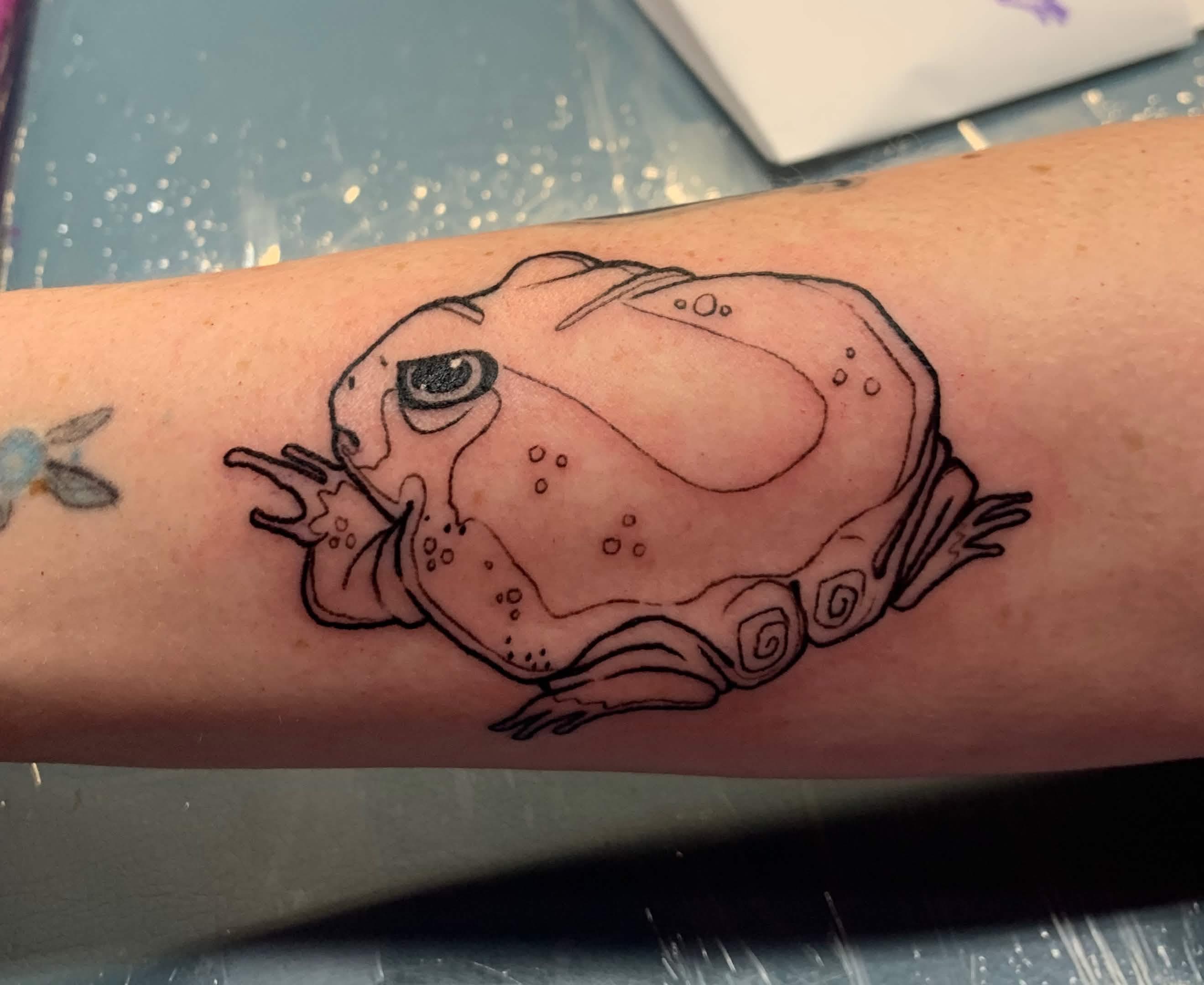 tattoo of a fat grumpy frog